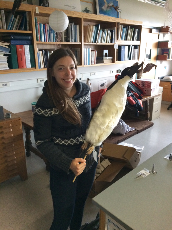 photo of Chantel Michelson holding a taxidermy penguin